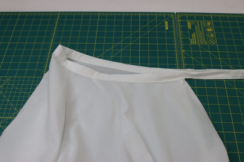 How To Topstitch Waistband To Secure To Skirt - Cotton Voile - Mood Fabrics - Selenite V Waist Ballgown Free Sewing Pattern Tutorial - MDF515 - Mood Fabrics Sewciety Blog - Topstitch the bottom edge of the waistband to the waistline of the skirt.