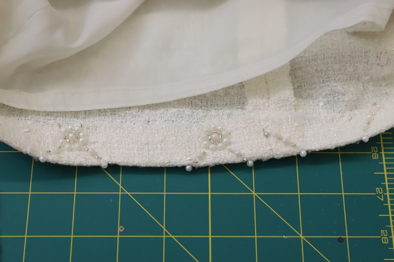 How To Hem Lining And Main Fabric - Beaded Tweed - Mood Fabrics - Deauville Cocktail Dress Free Sewing Pattern Tutorial - MDF517 - Mood Fabrics Sewciety Blog - Hem the lining and the main fabric.