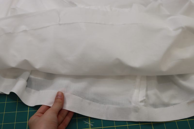 How To Press Petticoat With Fusible Tape - Cotton Voile - Mood Fabrics - Selenite V Waist Ballgown Free Sewing Pattern Tutorial - MDF515 - Mood Fabrics Sewciety Blog - Hem the petticoat with fusible hem tape.