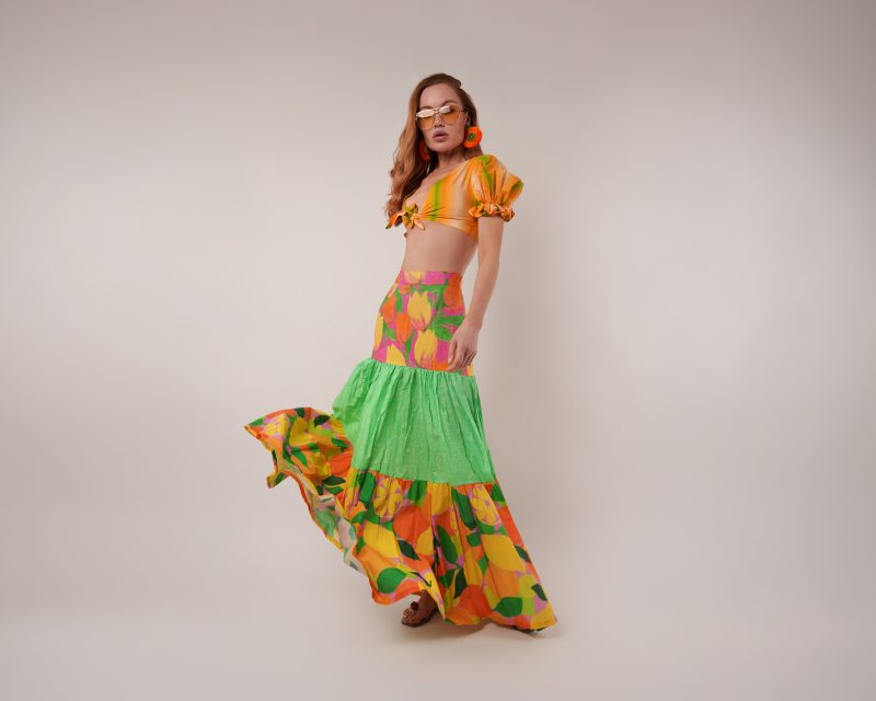 Model wearing Reed Swimsuit Daylily Skirt Sewing Pattern posing for Resort Wear Sewing Project Ideas. Free Sewing Pattern PDF from Mood Fabrics Sewciety Blog.
