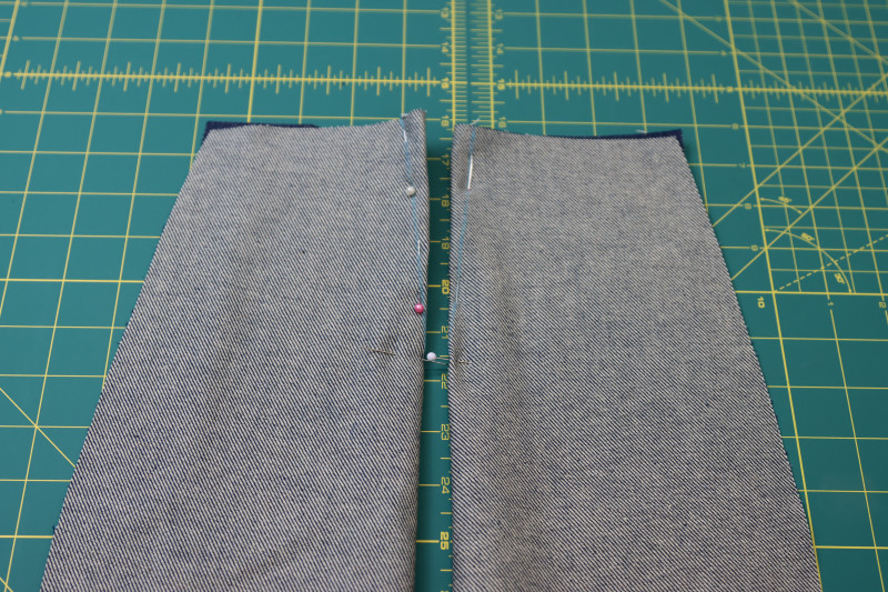 How To Pin Back Pants Pieces Right Sides Together At Dart Lines - Cotton Denim Twill - Mood Fabrics - Merit Jumpsuit Free Sewing Pattern Tutorial - MDF525 - Mood Fabrics Sewciety Blog - Pin the back pants pieces right sides together at the dart lines.