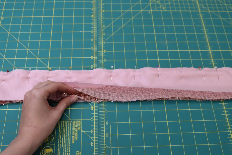 How To Sandwich Sequined Waistbands In Between The Lining Waistbands And Pin - Baby Sequin Mesh - Mood Fabrics - Morganite Waistcoat Ensemble Free Sewing Pattern Tutorial - MDF519 - Mood Fabrics Sewciety Blog - Sandwich the sequined waistbands in between the lining waistbands and pin.