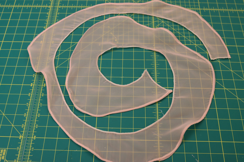How To Finish Edges Of Spiral Ruffles With Serger - Polester Chiffon - Mood Fabrics - Pyrite Pleated Dress Free Sewing Pattern Tutorial - MDF527 - Mood Fabrics Sewciety Blog - Finish the edges of the spiral ruffles with a serger.