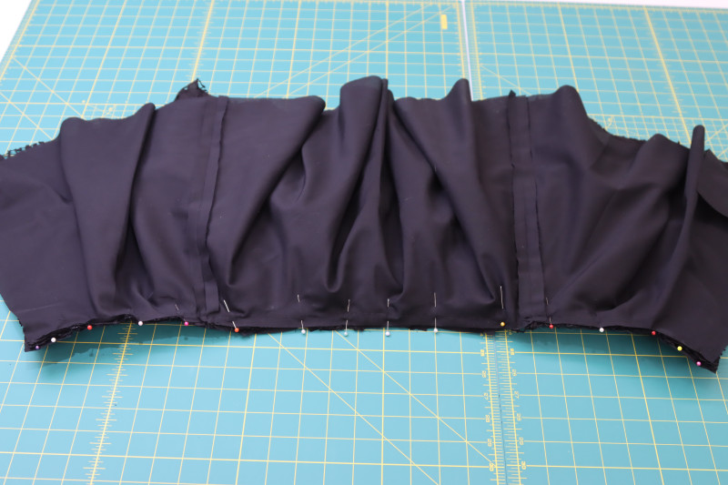 How To Pin Skirt Waistline To Corset Waistline Right Sides Together - Floral Guipure Lace - Mood Fabrics - Reims Soirée Dress Free Sewing Pattern Tutorial - MDF521 - Mood Fabrics Sewciety Blog - Pin the skirt waistline to the corset waistline right sides together.