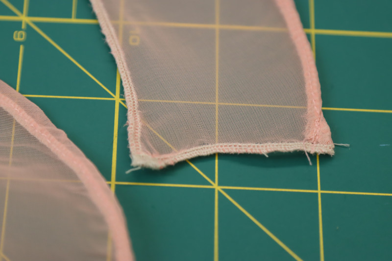 How To Sew Rolled Serged Edges Of Spiral Ruffles - Polester Chiffon - Mood Fabrics - Pyrite Pleated Dress Free Sewing Pattern Tutorial - MDF527 - Mood Fabrics Sewciety Blog - Sew the rolled serged edges of the spiral ruffles.