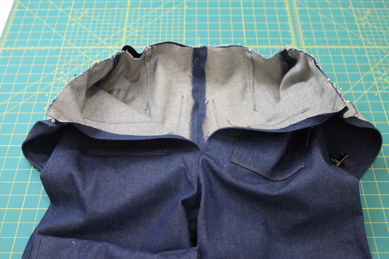 How To Pin Waistline Top To Pants Pinned - Cotton Denim Twill - Mood Fabrics - Merit Jumpsuit Free Sewing Pattern Tutorial - MDF525 - Mood Fabrics Sewciety Blog - Pin the waistline of the top to the waistline of the pants.