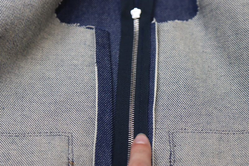 How To Pin Sew Center Front Zipper First Side - 27.5 Inch Zipper - Mood Fabrics - Merit Jumpsuit Free Sewing Pattern Tutorial - MDF525 - Mood Fabrics Sewciety Blog - Pin and sew one side of the zipper right sides together with one side of your center front opening.