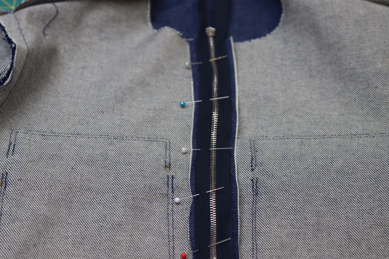 How To Pin Sew Center Front Zipper Second Side - 27.5 Inch Zipper - Mood Fabrics - Merit Jumpsuit Free Sewing Pattern Tutorial - MDF525 - Mood Fabrics Sewciety Blog - Pin and sew the other side of the zipper to the opposite side of the center front opening.