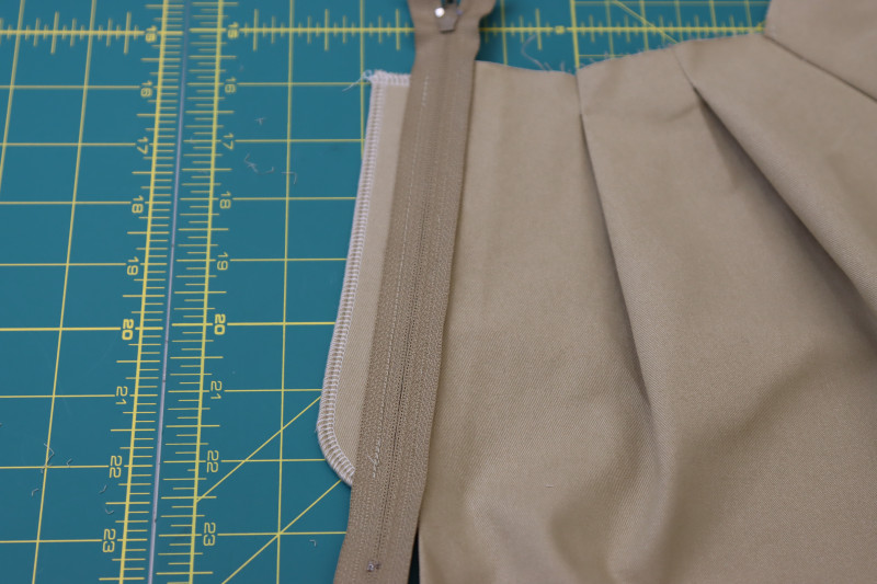 How To Pin Sew Zipper Right Sides Together With Fly Facing - Regular Zipper - Mood Fabrics - Lucca Tailored Barrel Leg Pants Free Sewing Pattern Tutorial - MDF524 - Mood Fabrics Sewciety Blog - Pin and sew the zipper right sides together with the fly facing.
