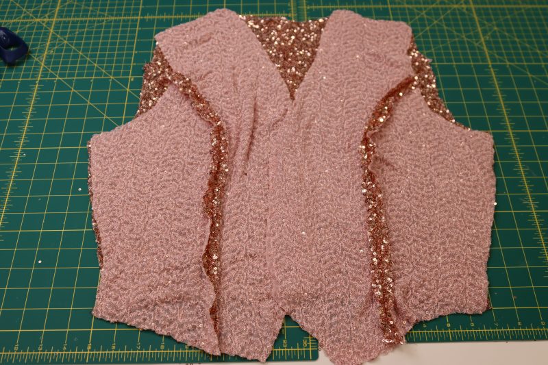 How To Layout Vest Front Pieces On Top Of The Vest Back Piece - Baby Sequin Mesh - Mood Fabrics - Morganite Waistcoat Ensemble Free Sewing Pattern Tutorial - MDF519 - Mood Fabrics Sewciety Blog - Lay the vest front pieces on top of the vest back piece, right sides together.