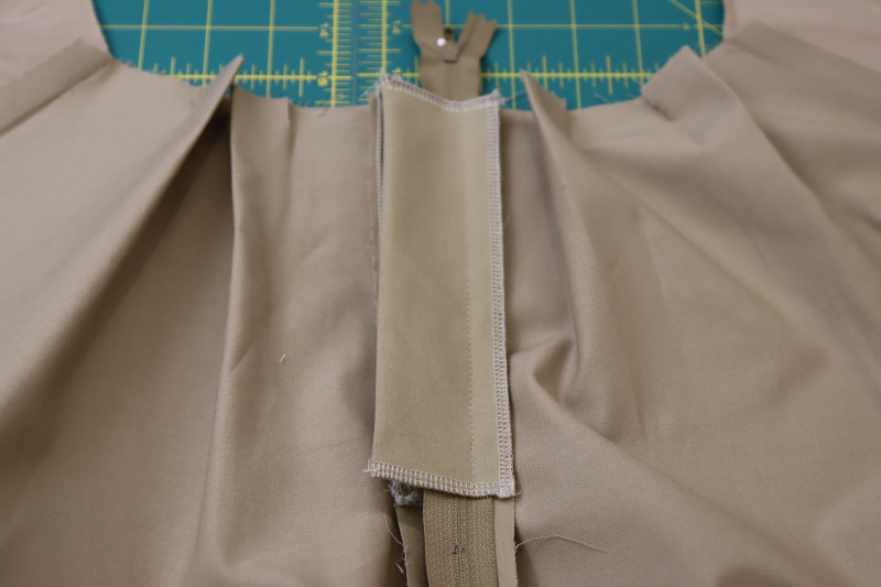 How To Sandwich Zipper Between Front Pants And Fly Shield - Regular Zipper - Mood Fabrics - Lucca Tailored Barrel Leg Pants Free Sewing Pattern Tutorial - MDF524 - Mood Fabrics Sewciety Blog - Sandwich the zipper between the front pants and the fly shield.
