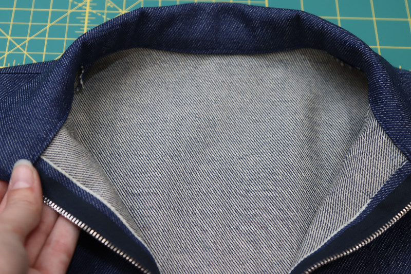 How To Sew Stitch In Ditch At Neckline - Gutermann Sew All Thread - Mood Fabrics - Merit Jumpsuit Free Sewing Pattern Tutorial - MDF525 - Mood Fabrics Sewciety Blog - Sew stitch in the neckline seam ditch to attach the inner layer of the collar to the neckline.
