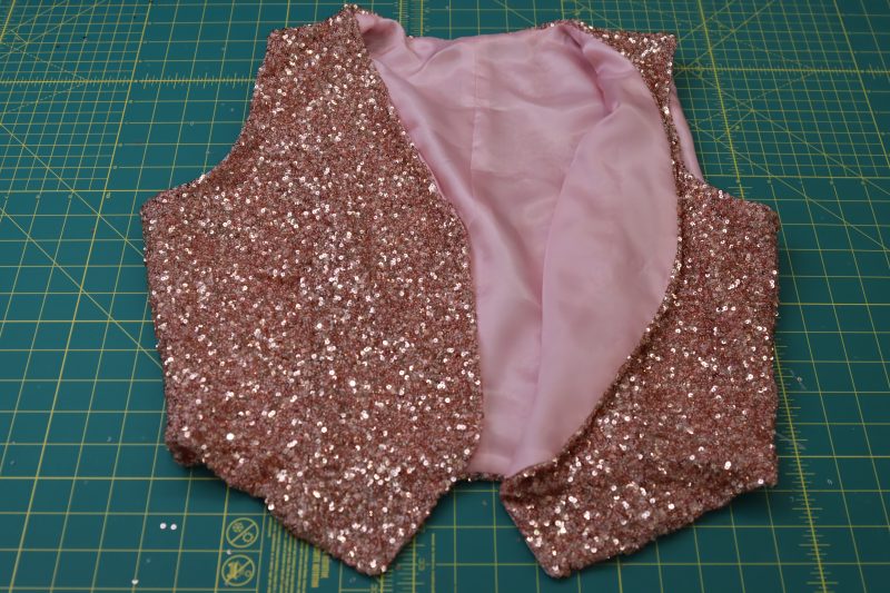 How To Flip Vest Right Sides Out Through The Gap - Baby Sequin Mesh - Mood Fabrics - Morganite Waistcoat Ensemble Free Sewing Pattern Tutorial - MDF519 - Mood Fabrics Sewciety Blog - Flip the vest right sides out through the gap.