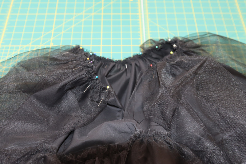 How To Pin Upper Tulle Layer To Petticoat Lining Waistline - Nylon Tulle - Mood Fabrics - Reims Soirée Dress Free Sewing Pattern Tutorial - MDF521 - Mood Fabrics Sewciety Blog - Pin the upper tulle layer to the petticoat lining waistline.