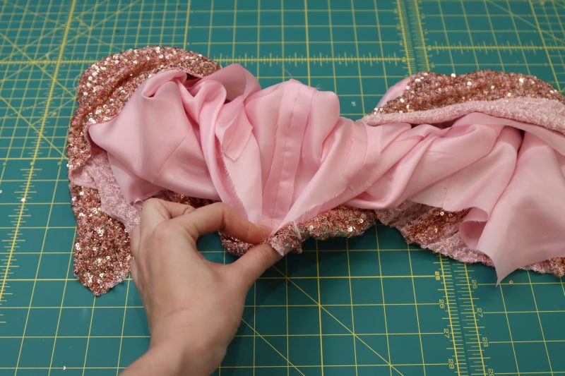 How To Wrap Lining And Main Fabric Around The Bulk Of The Vest - Twill Lining - Mood Fabrics - Morganite Waistcoat Ensemble Free Sewing Pattern Tutorial - MDF519 - Mood Fabrics Sewciety Blog - Wrap the lining and main fabric around the bulk of the vest and hold them right sides together.