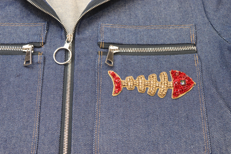 How To Place Applique Placement On Jumpsuit - Skeletal Fish Applique - Mood Fabrics - Merit Jumpsuit Free Sewing Pattern Tutorial - MDF525 - Mood Fabrics Sewciety Blog - Place the applique where you want it to go on the jumpsuit.