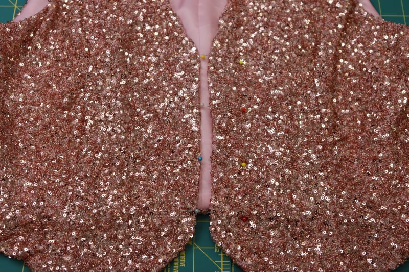 How To Mark Locations Of The Buttons And Button Holes With Pins - Pearl Buttons - Mood Fabrics - Morganite Waistcoat Ensemble Free Sewing Pattern Tutorial - MDF519 - Mood Fabrics Sewciety Blog - Mark the locations of the buttons and button holes with pins.