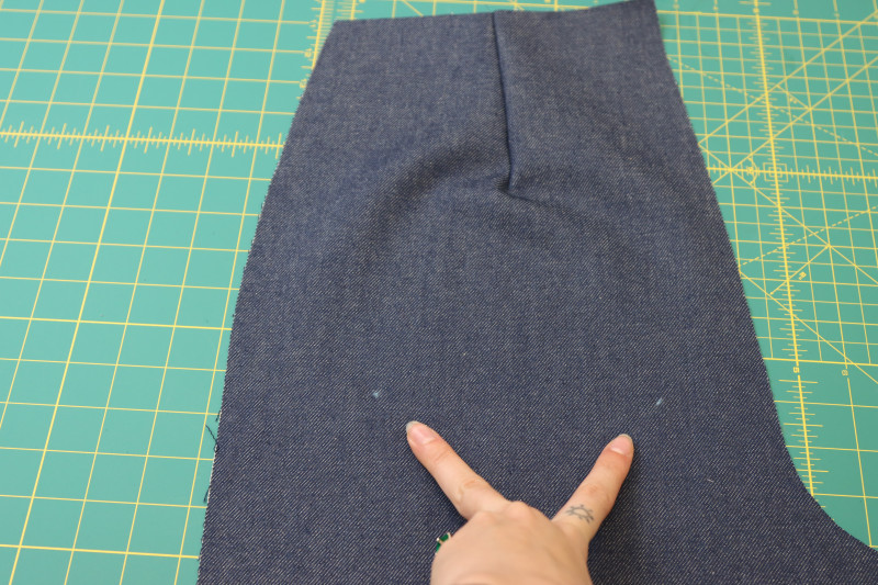 How To Mark Back Pocket Placement Marked With Chalk - Cotton Denim Twill - Mood Fabrics - Merit Jumpsuit Free Sewing Pattern Tutorial - MDF525 - Mood Fabrics Sewciety Blog - Mark the location of the back pockets on the backs of the pants with tailor’s chalk.