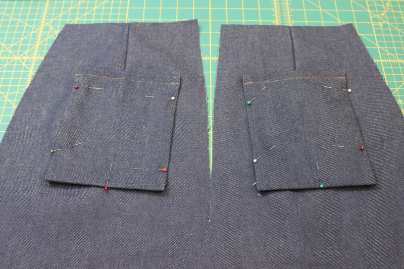 How To Pin Back Pockets Pinned To Pants - Cotton Denim Twill - Mood Fabrics - Merit Jumpsuit Free Sewing Pattern Tutorial - MDF525 - Mood Fabrics Sewciety Blog - Pin the back pockets to the backs of the pants at the chalk lines.