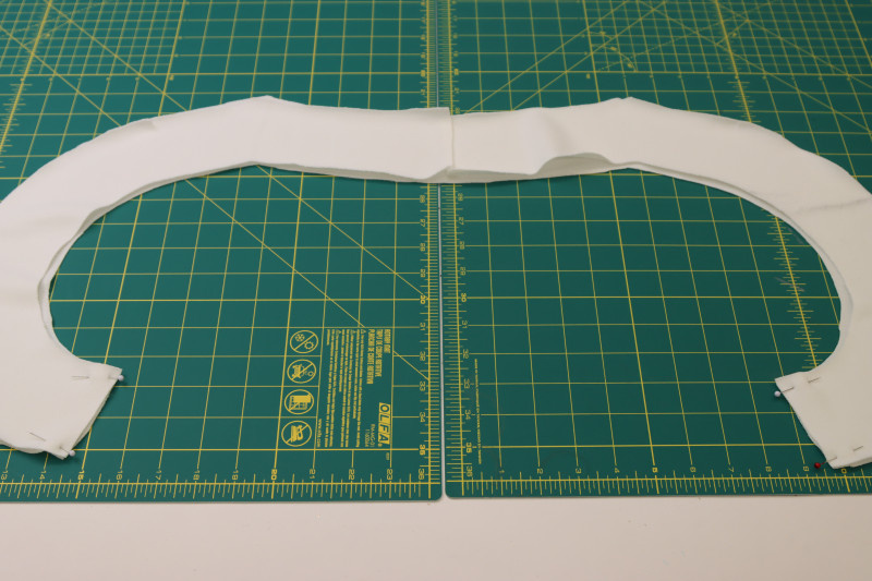How To Pin Ends Of The Front And Back Neckling Facing Pieces Together - Stretch Liverpool Knit - Mood Fabrics - Merano Balloon Sleeve Blouse Free Sewing Pattern Tutorial - MDF522 - Mood Fabrics Sewciety Blog - Pin the ends of the front and back neckling facing pieces together.