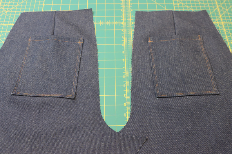 How To Sew Back Pockets Sewn To Pants Gold Thread - Cotton Denim Twill - Mood Fabrics - Merit Jumpsuit Free Sewing Pattern Tutorial - MDF525 - Mood Fabrics Sewciety Blog - Sew the sides and bottoms of the back pockets to the backs of the pants with the gold contrast thread.