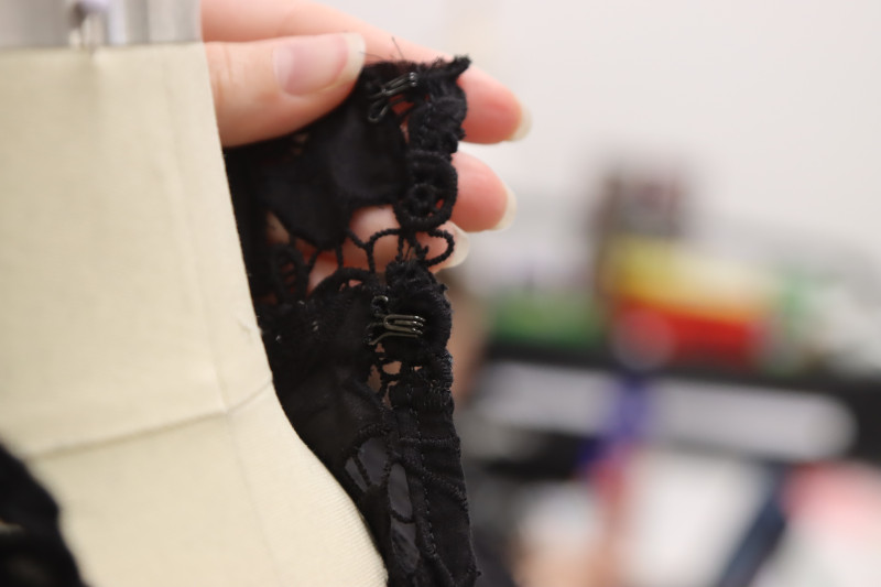 How To Sew Hook Closures To Opposite Side Of Collar By Hand - Hook And Eye Closures - Mood Fabrics - Reims Soirée Dress Free Sewing Pattern Tutorial - MDF521 - Mood Fabrics Sewciety Blog - Hand sew hook closures to the opposite side of the collar.