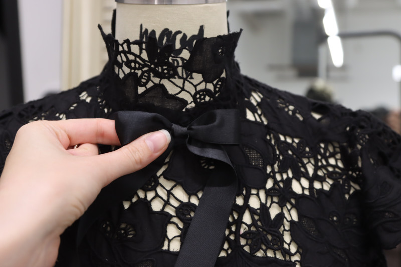 How To Sew Bow To Center Front Neckline By Hand - Satin Ribbon - Mood Fabrics - Reims Soirée Dress Free Sewing Pattern Tutorial - MDF521 - Mood Fabrics Sewciety Blog - Hand sew the bow to the center front neckline.