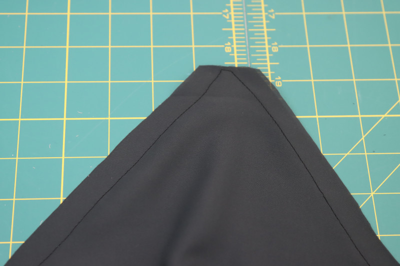 How To Clip Top Corner Of Front Neckline - Double Polyester Georgette - Mood Fabrics - Pyrite Pleated Dress Free Sewing Pattern Tutorial - MDF527 - Mood Fabrics Sewciety Blog - Clip the top corner of the front neckline.