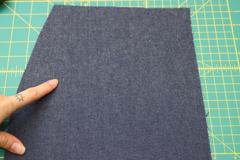 How To Mark Front Pocket Placement Marked With Chalk - Cotton Denim Twill - Mood Fabrics - Merit Jumpsuit Free Sewing Pattern Tutorial - MDF525 - Mood Fabrics Sewciety Blog - Mark the location of the front pockets on the fronts of the pants with tailor’s chalk.