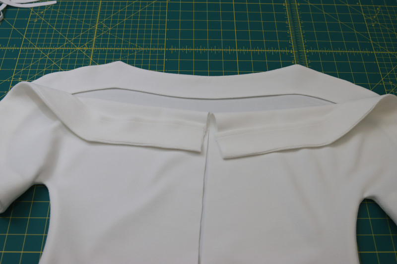 How To Press Facings Toward The Inside Of The Blouse - Stretch Liverpool Knit - Mood Fabrics - Merano Balloon Sleeve Blouse Free Sewing Pattern Tutorial - MDF522 - Mood Fabrics Sewciety Blog - Press the facings toward the inside of the blouse.