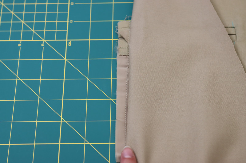 How To Sew Side Seam Of Pocket Lining To Notch Of Welt Pocket - Stretch Polester Twill Lining - Mood Fabrics - Lucca Tailored Barrel Leg Pants Free Sewing Pattern Tutorial - MDF524 - Mood Fabrics Sewciety Blog - Sew the side seam of the pocket lining to the notch of the welt pocket.