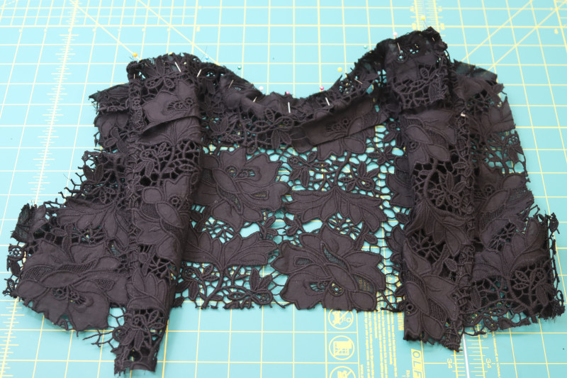 How To Pin Bottom Of Collar Right Sides Together With Neckline Of Top - Floral Guipure Lace - Mood Fabrics - Reims Soirée Dress Free Sewing Pattern Tutorial - MDF521 - Mood Fabrics Sewciety Blog - Pin the bottom of the collar right sides together with the neckline of the top.