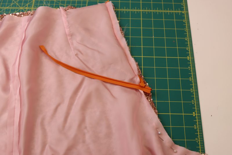 How To Sew Zipper Tape Between Lining And Main Fabric - Invisible Zipper - Mood Fabrics - Morganite Waistcoat Ensemble Free Sewing Pattern Tutorial - MDF519 - Mood Fabrics Sewciety Blog - Sew the zipper tape between the lining and the main fabric.