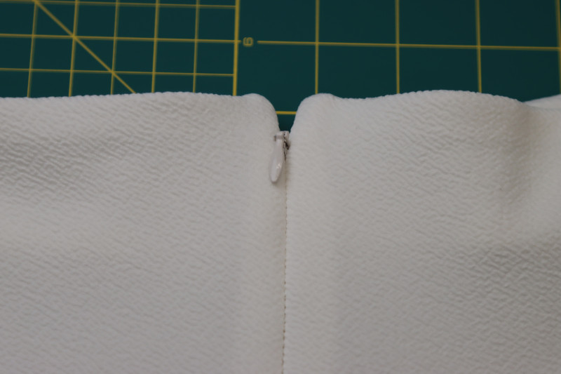How To Clip Corners Of The Neckline And Flip It Right Sides Out - Stretch Liverpool Knit - Mood Fabrics - Merano Balloon Sleeve Blouse Free Sewing Pattern Tutorial - MDF522 - Mood Fabrics Sewciety Blog - Clip the corners of the neckline and flip it right sides out.
