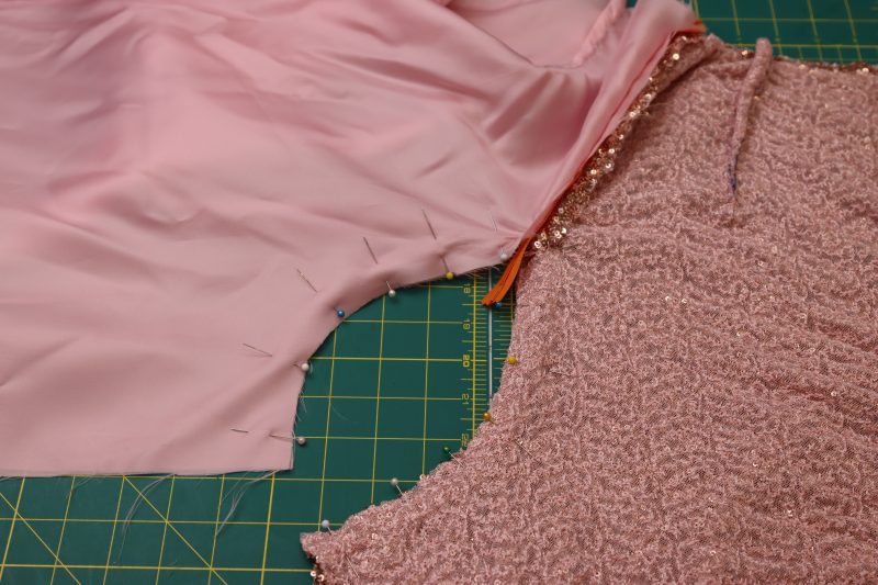 How To Pin Back Crotch Seams Under The Zipper - Baby Sequin Mesh - Mood Fabrics - Morganite Waistcoat Ensemble Free Sewing Pattern Tutorial - MDF519 - Mood Fabrics Sewciety Blog - Pin the back crotch seams under the zipper.