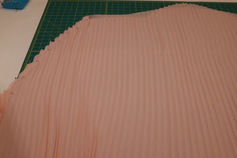 How To Pin One Side Seam Of Skirt - Accordion Pleated Chiffon - Mood Fabrics - Pyrite Pleated Dress Free Sewing Pattern Tutorial - MDF527 - Mood Fabrics Sewciety Blog - Pin one of the side seams of the skirt.