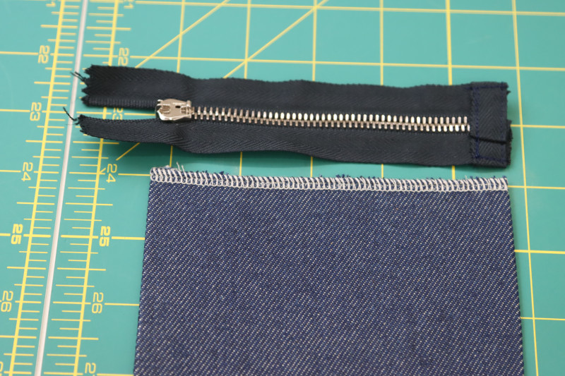 How To Sew Zipper Stopper Created With Tape - 9 Inch Zipper - Mood Fabrics - Merit Jumpsuit Free Sewing Pattern Tutorial - MDF525 - Mood Fabrics Sewciety Blog - Sew a new stopper at the end of the zipper teeth with zipper tape.