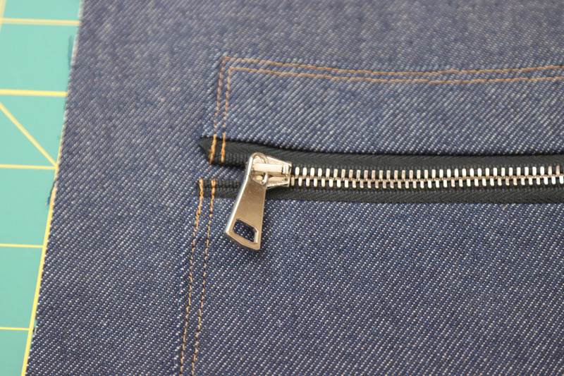 How To Secure Zipper Pull - 9 Inch Zipper - Mood Fabrics - Merit Jumpsuit Free Sewing Pattern Tutorial - MDF525 - Mood Fabrics Sewciety Blog - Secure the zipper pull to the zipper using the tools it came with.