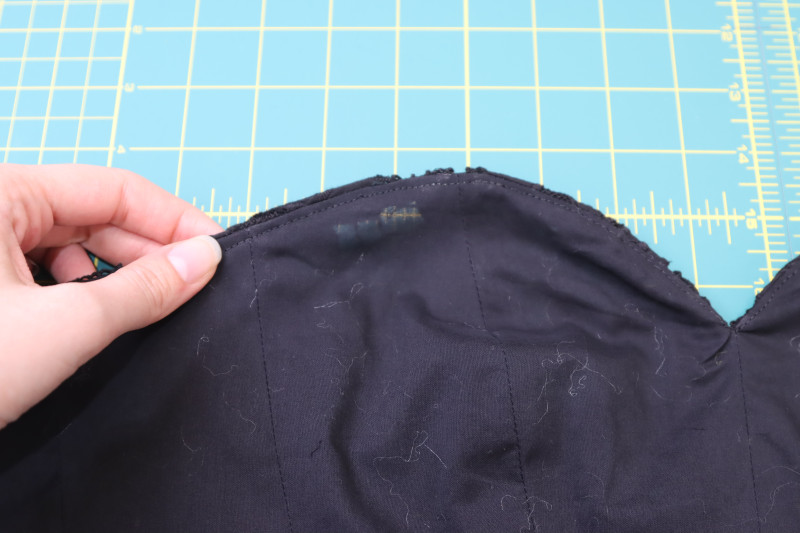 How To Understitch Lining Corset To Seam Allowance Of Neckline - Cotton Voile - Mood Fabrics - Reims Soirée Dress Free Sewing Pattern Tutorial - MDF521 - Mood Fabrics Sewciety Blog - Understitch the lining corset to the seam allowance of the neckline.