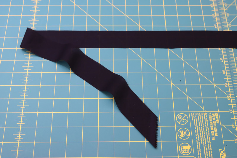 How To Cut Strip Of Bias Tape Out Of Lining Fabric - Cotton Voile - Mood Fabrics - Reims Soirée Dress Free Sewing Pattern Tutorial - MDF521 - Mood Fabrics Sewciety Blog - Cut a strip of bias tape out of the lining fabric.