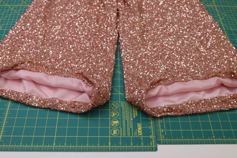 How To Hem Both Pant Legs - Baby Sequin Mesh - Mood Fabrics - Morganite Waistcoat Ensemble Free Sewing Pattern Tutorial - MDF519 - Mood Fabrics Sewciety Blog - Repeat for both pant legs.