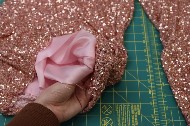 How To Hold Pants Hems Right Sides Together - Baby Sequin Mesh - Mood Fabrics - Morganite Waistcoat Ensemble Free Sewing Pattern Tutorial - MDF519 - Mood Fabrics Sewciety Blog - Hold the pants hems right sides together.