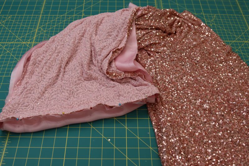 How To Pin Around The Perimeter Of The Pant Legs - Baby Sequin Mesh - Mood Fabrics - Morganite Waistcoat Ensemble Free Sewing Pattern Tutorial - MDF519 - Mood Fabrics Sewciety Blog - Pin around the perimeter of the pant legs.