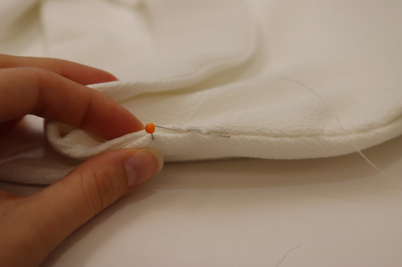 How To Sew Ladder Stitch By Hand To Connect The Front And Back Blouse Pieces At The Shoulders - Gutermann Sew All Thread - Mood Fabrics - Merano Balloon Sleeve Blouse Free Sewing Pattern Tutorial - MDF522 - Mood Fabrics Sewciety Blog - Sew a ladder stitch by hand to connect the front and back blouse pieces at the shoulders.