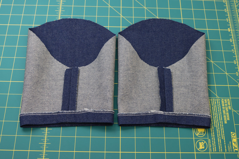 How To Fold Sleeve Bottom Edge Folded - Cotton Denim Twill - Mood Fabrics - Merit Jumpsuit Free Sewing Pattern Tutorial - MDF525 - Mood Fabrics Sewciety Blog - Fold the bottom edge of the sleeve toward the wrong side of the fabric.