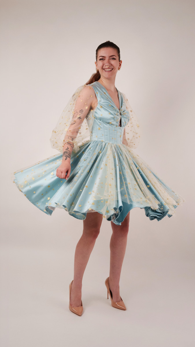Model wearing The Cicely Dress Sewing Pattern posing for Corset Sewing Project Ideas. Free Sewing Pattern PDF from Mood Fabrics Sewciety Blog.