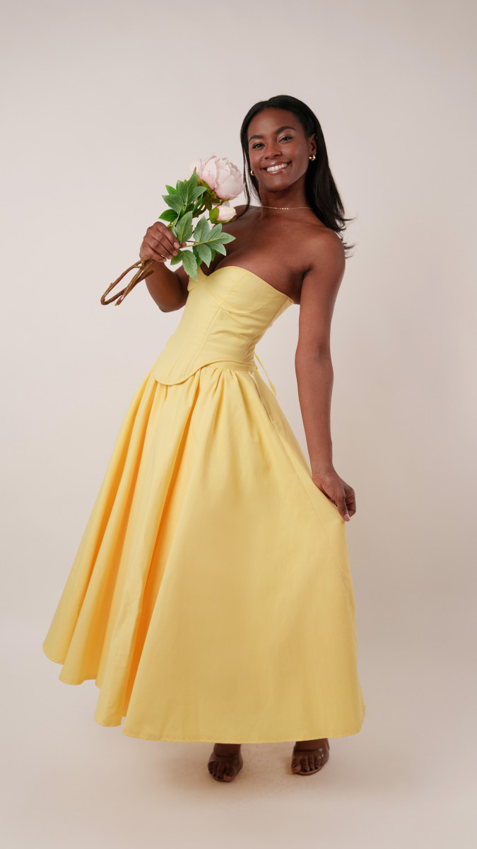 Model wearing The Madison Tea Length Dress Sewing Pattern posing for Corset Sewing Project Ideas. Free Sewing Pattern PDF from Mood Fabrics Sewciety Blog.