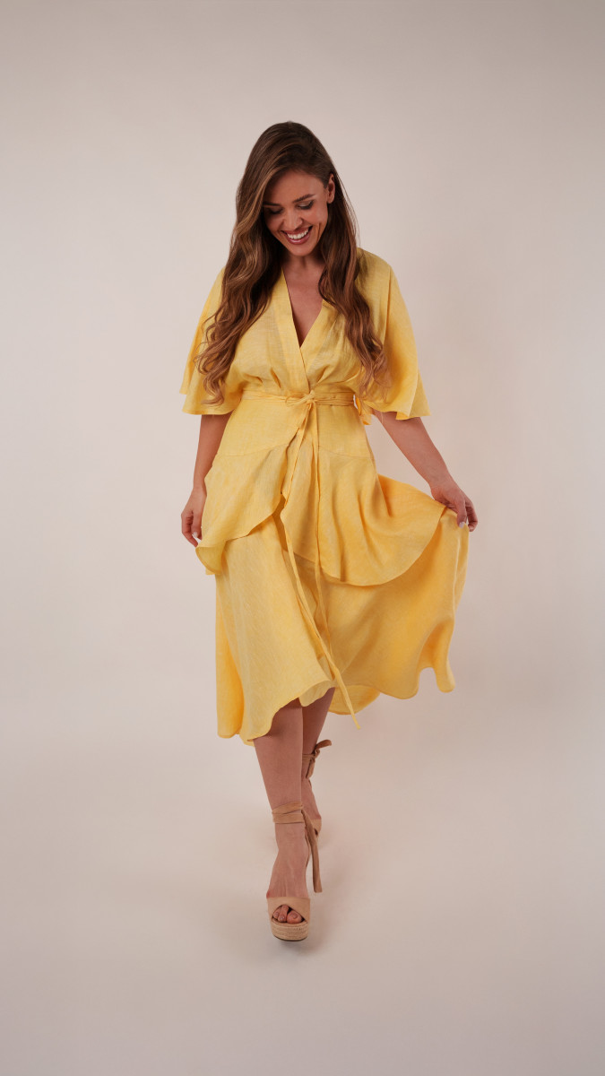 Model wearing Nettle Wrap Dress Redux Sewing Pattern posing for Transitional Spring Sewing Project Ideas. Free Sewing Pattern PDF from Mood Fabrics Sewciety Blog.