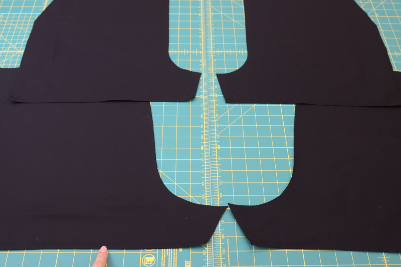 How To Sew Pants Lining Shorts Hem - Black Quilting Cotton - Mood Fabrics - Matrix Shawl Collar Ensemble Free Sewing Pattern Tutorial - MDF543 - Mood Fabrics Sewciety Blog - Sew a double rolled ¼ inch hem into the bottoms of the pants lining shorts.