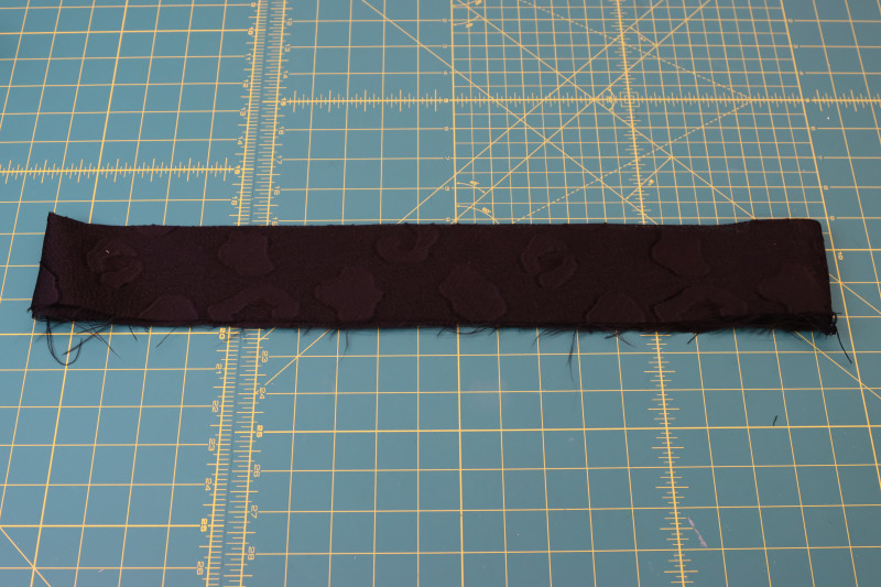 How To Fold Waistband Wrong Sides Together - Textured Burnout Brocade - Mood Fabrics - Matrix Shawl Collar Ensemble Free Sewing Pattern Tutorial - MDF543 - Mood Fabrics Sewciety Blog - Fold the waistband in half wrong sides together.